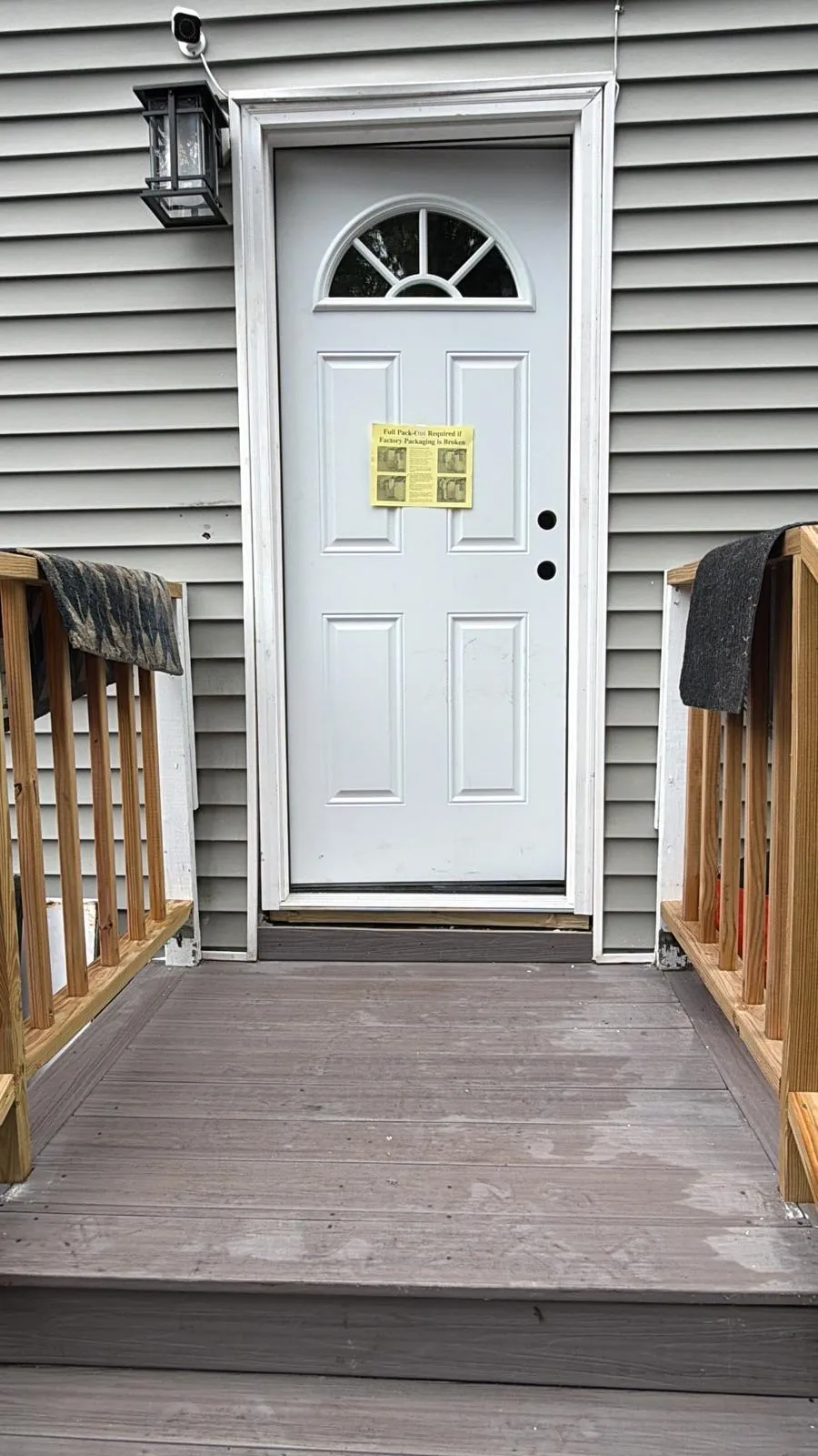 White exterior door with vinyl siding installed by Mosquera Construction in Connecticut