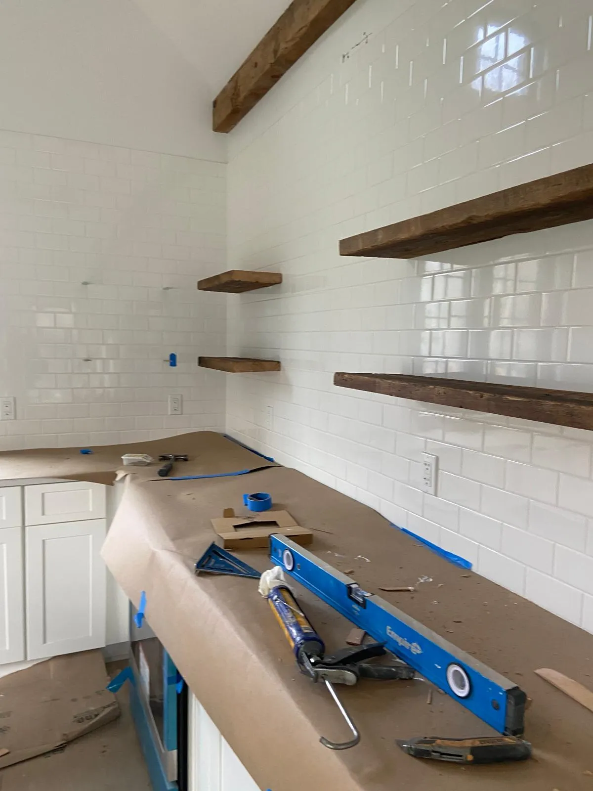 Kitchen with floating shelves and subway tile remodeled by Mosquera Construction in Connecticut