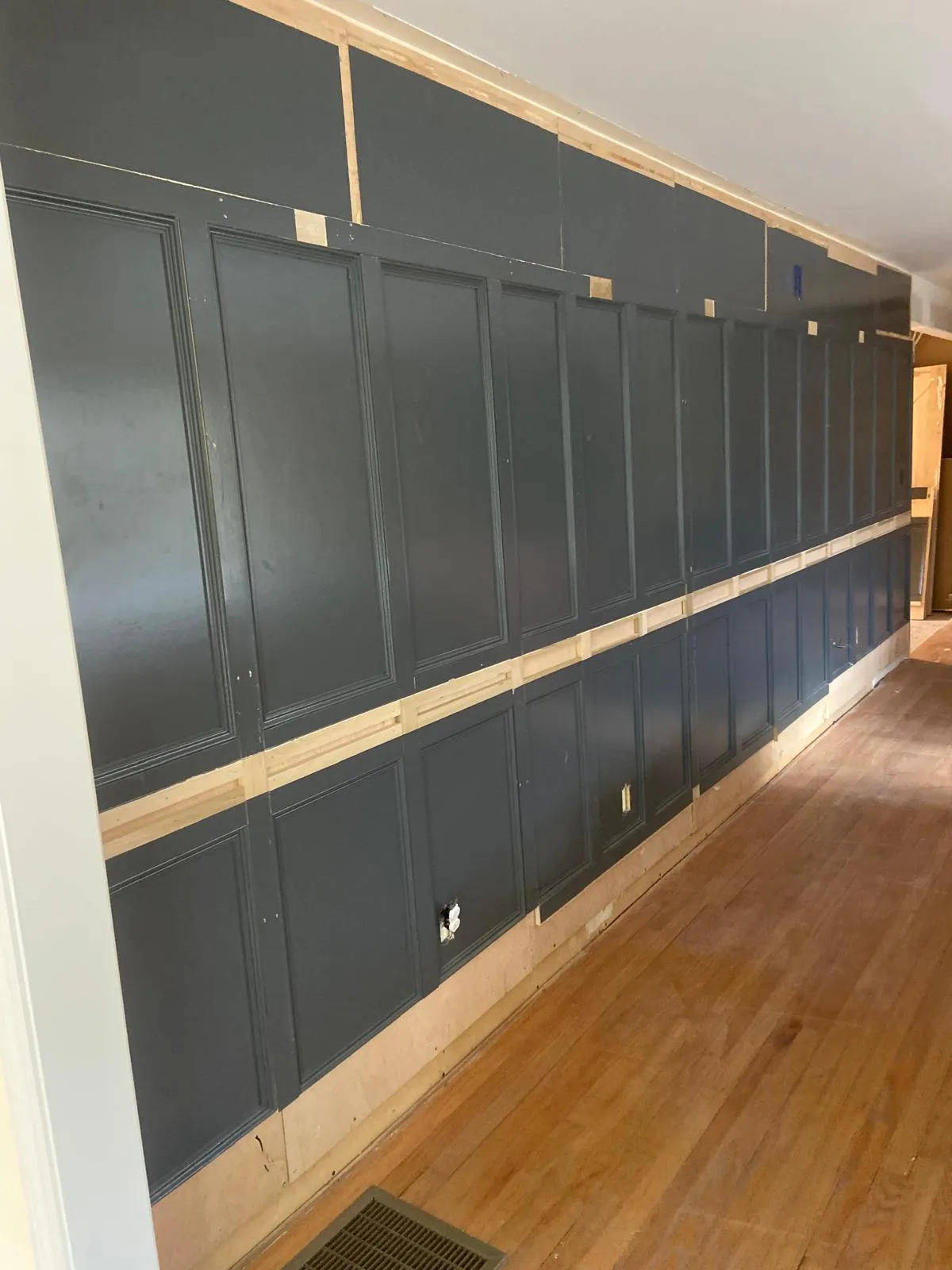 Wainscoting painted a dark color by Mosquera Construction in Connecticut