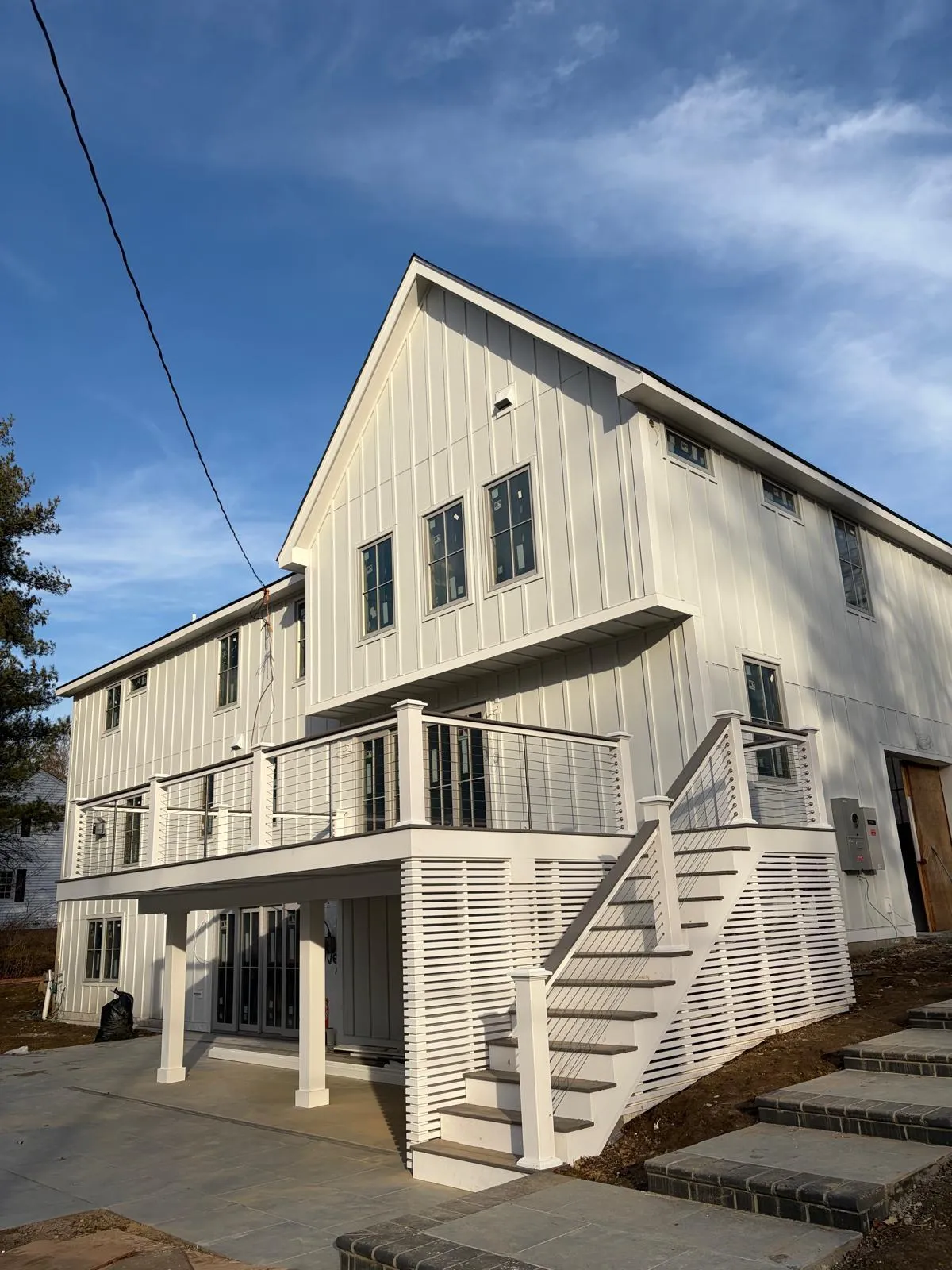 Finished deck with white railings and stairs built by Mosquera Construction in Connecticut