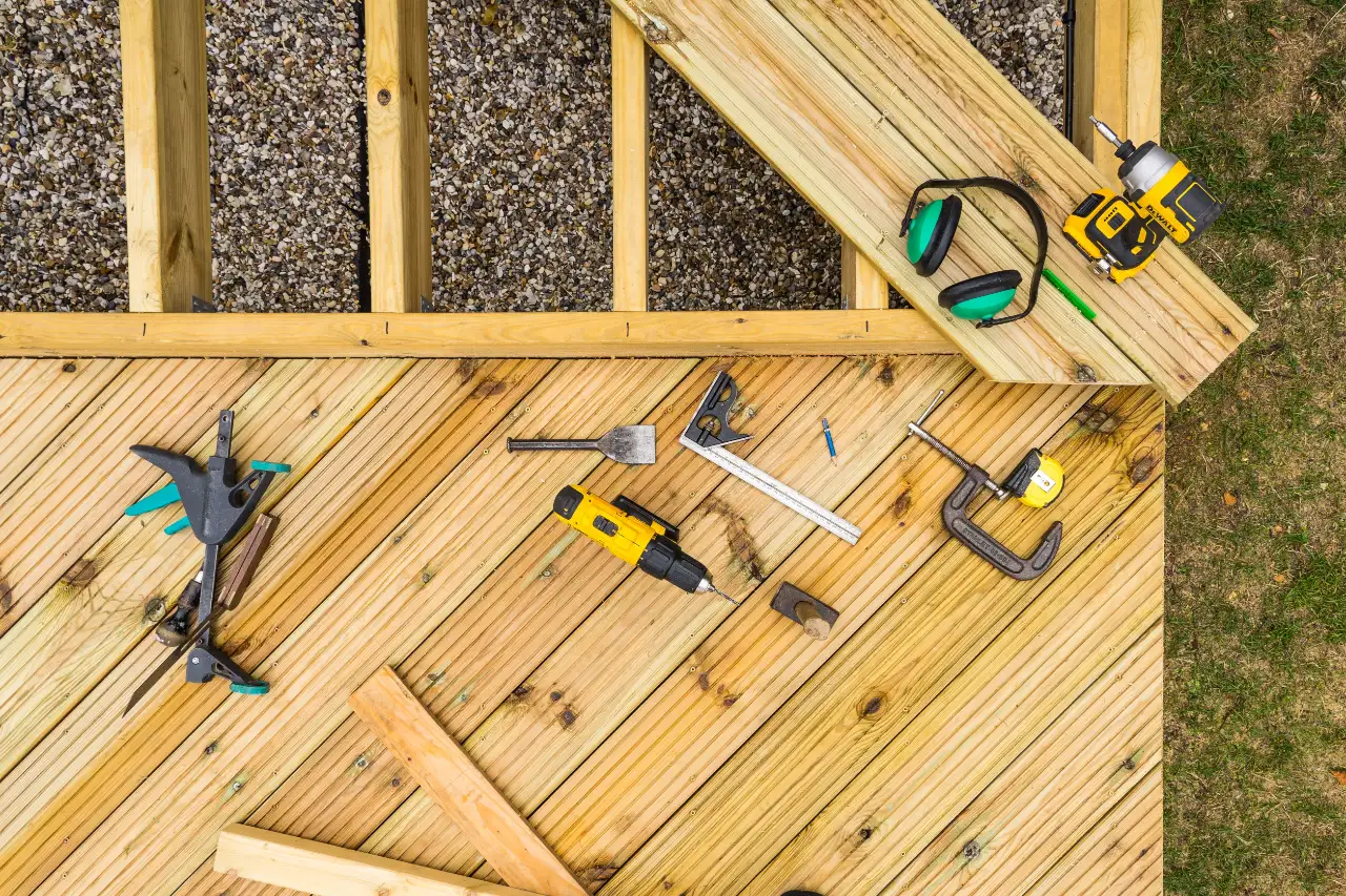 Tools on wood deck boards during a repair