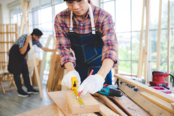 wooden workshop concept, carpenter team craftsman person working with a wood work construction tool